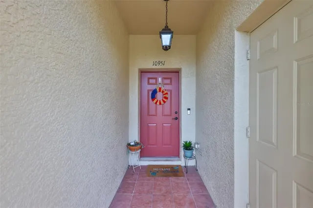a hallway with front door and wooden floor