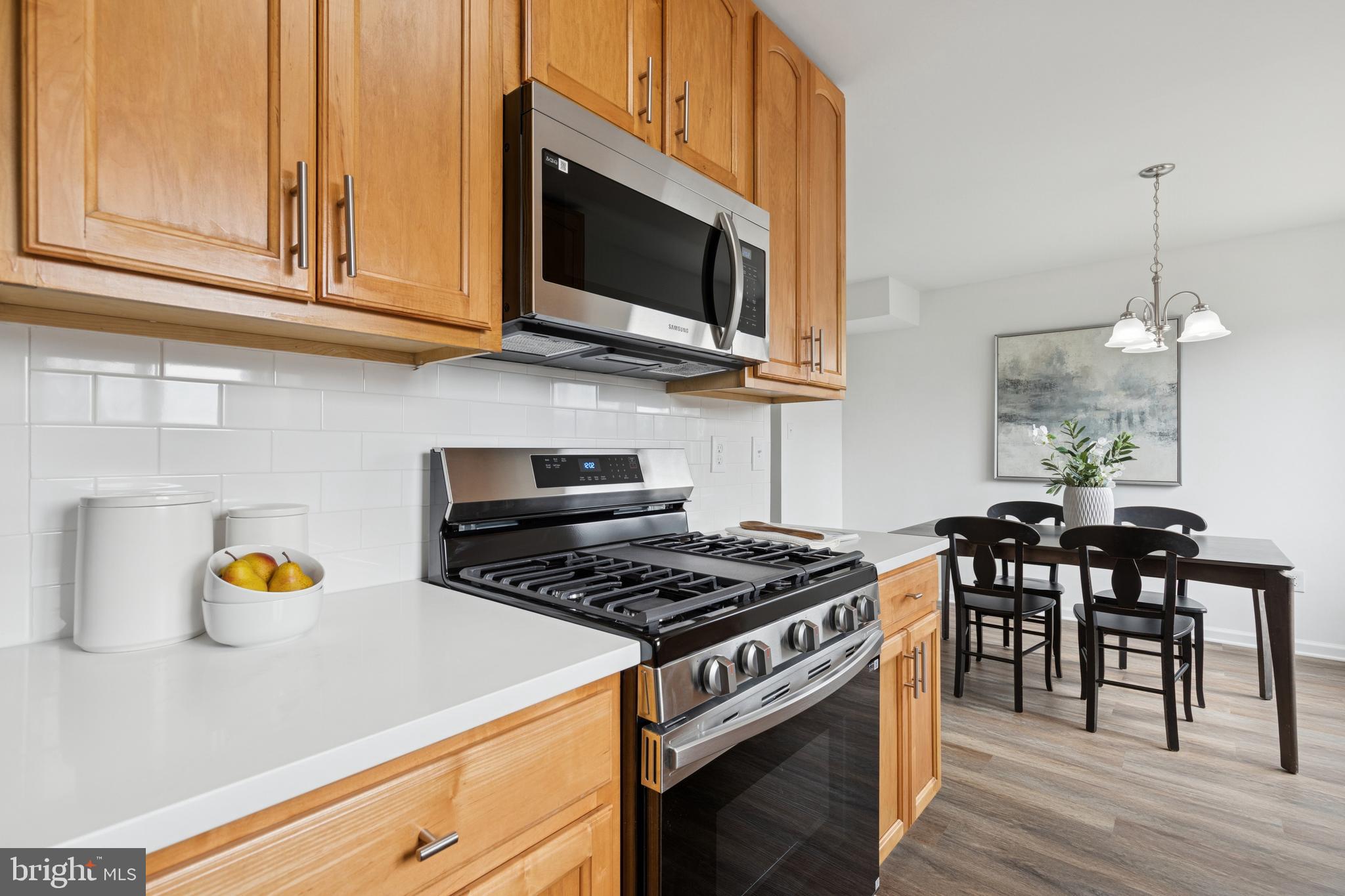8737 Inquiry Court Walkersville, MD 21793 - Photo 21 of 56 a kitchen with stainless steel appliances granite countertop a stove a sink and a microwave