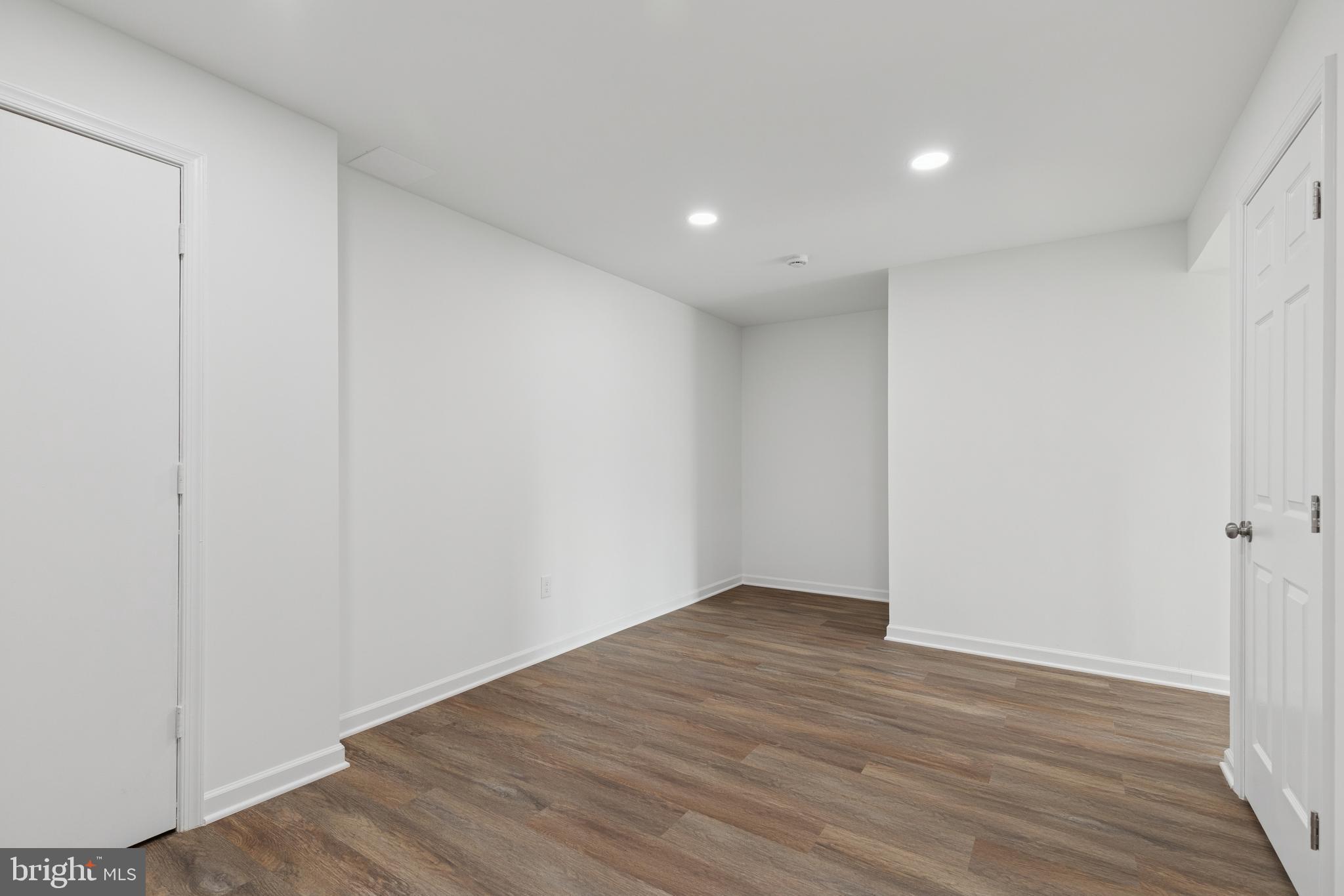 8737 Inquiry Court Walkersville, MD 21793 - Photo 39 of 56 a view of an empty room with wooden floor