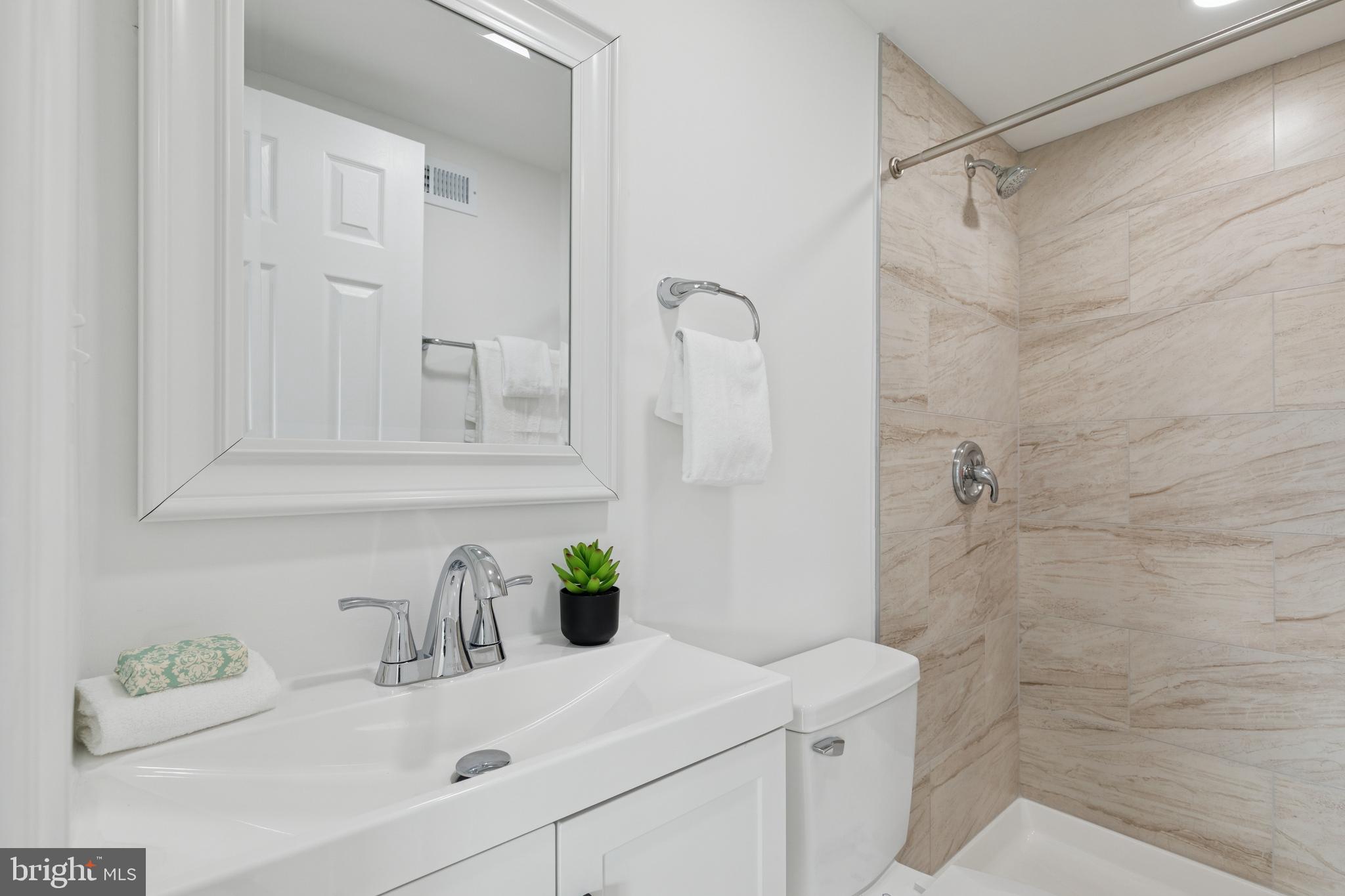 8737 Inquiry Court Walkersville, MD 21793 - Photo 43 of 56 a bathroom with a sink vanity and shower