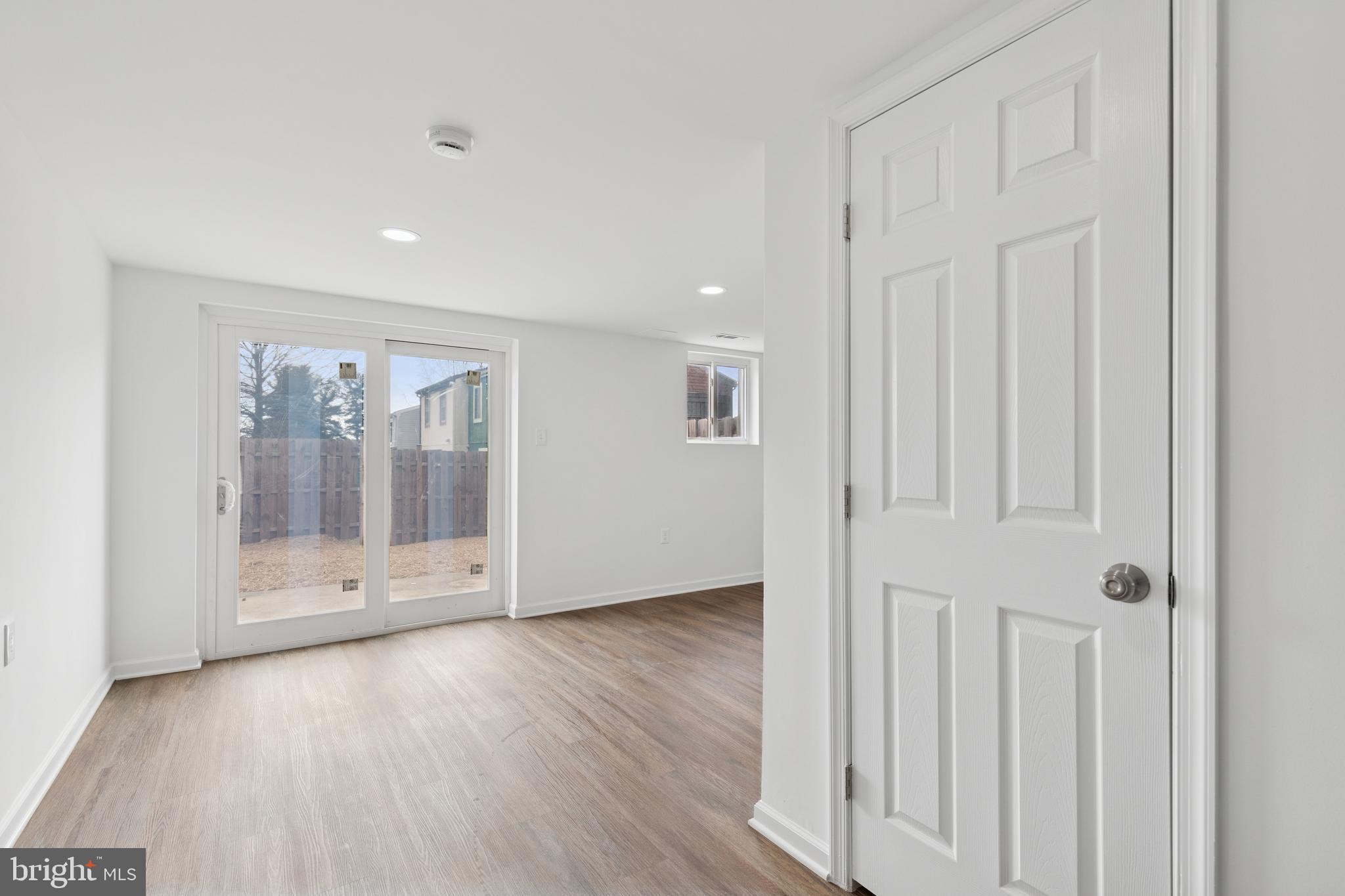 8737 Inquiry Court Walkersville, MD 21793 - Photo 44 of 56 a view of an empty room with wooden floor and entryway