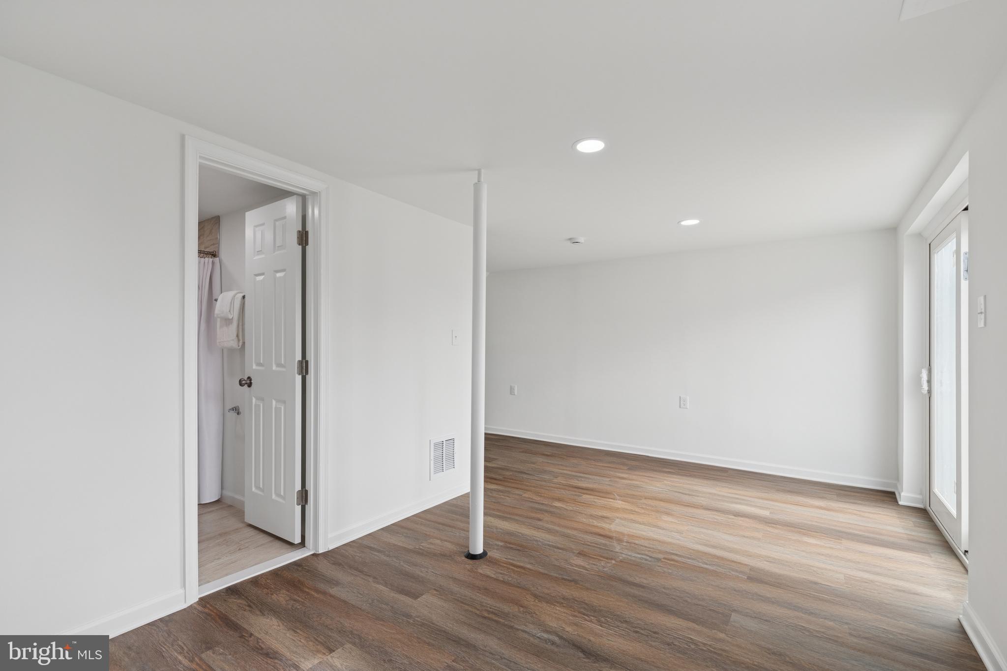 8737 Inquiry Court Walkersville, MD 21793 - Photo 45 of 56 a view of an empty room with wooden floor and closet