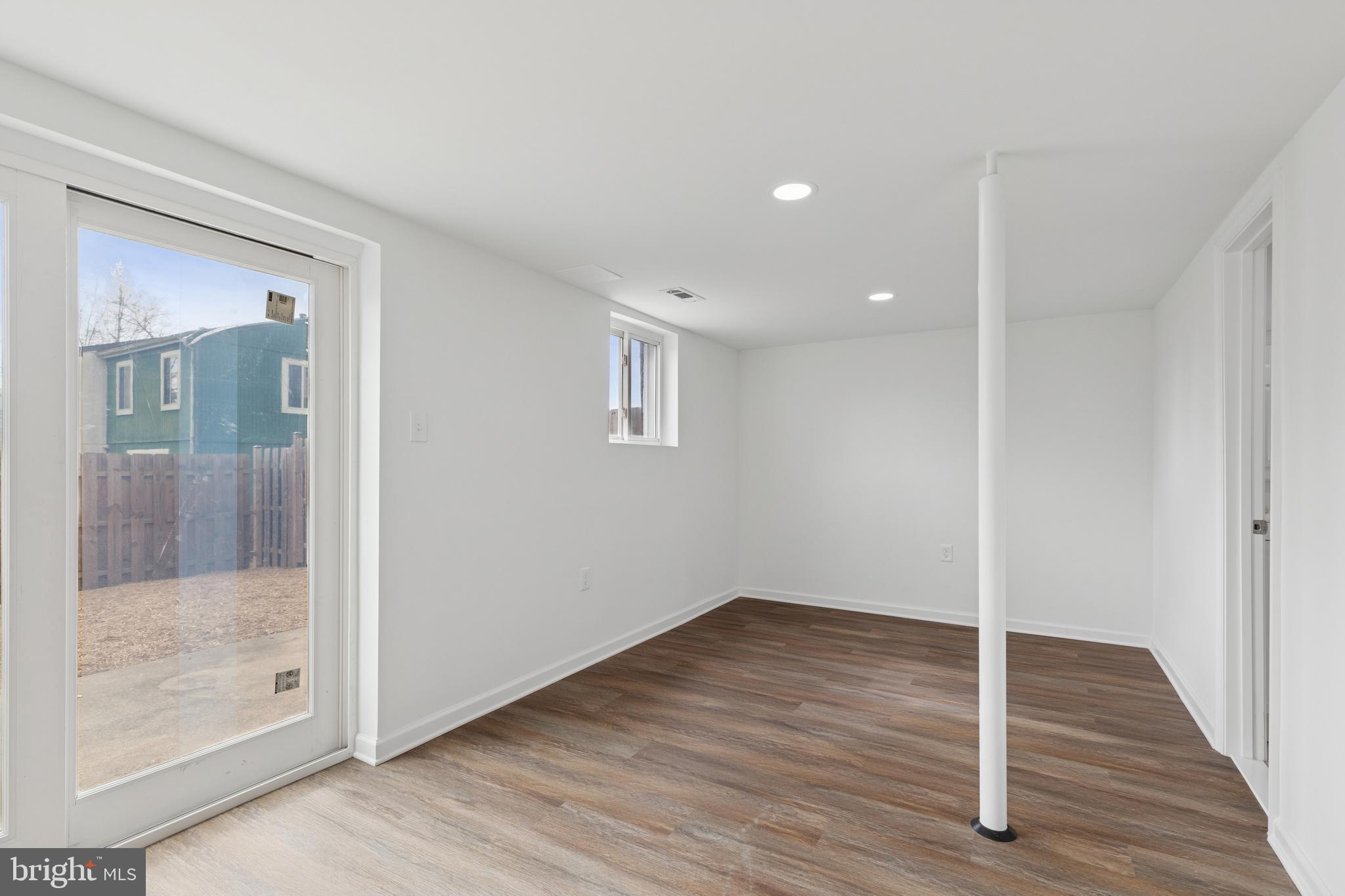 8737 Inquiry Court Walkersville, MD 21793 - Photo 47 of 56 a view of an empty room with wooden floor and a glass door