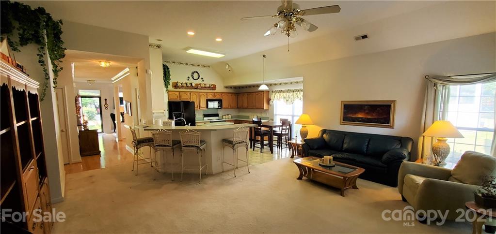 6612 Reedy Creek Road Charlotte, NC 28215 - Photo 14 of 31 a living room with furniture and a flat screen tv