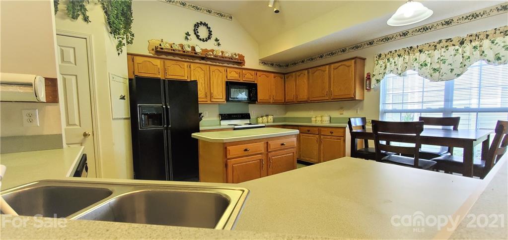 6612 Reedy Creek Road Charlotte, NC 28215 - Photo 8 of 31 a kitchen that has a sink and a stove in it