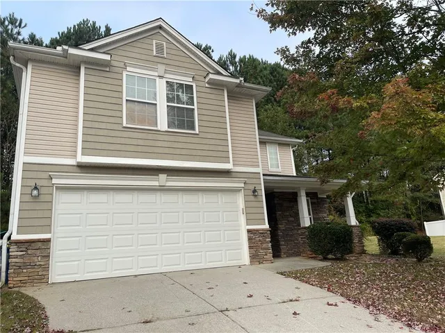 a front view of a house with a garage