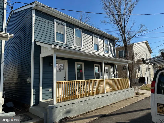 a view of a brick house with large windows