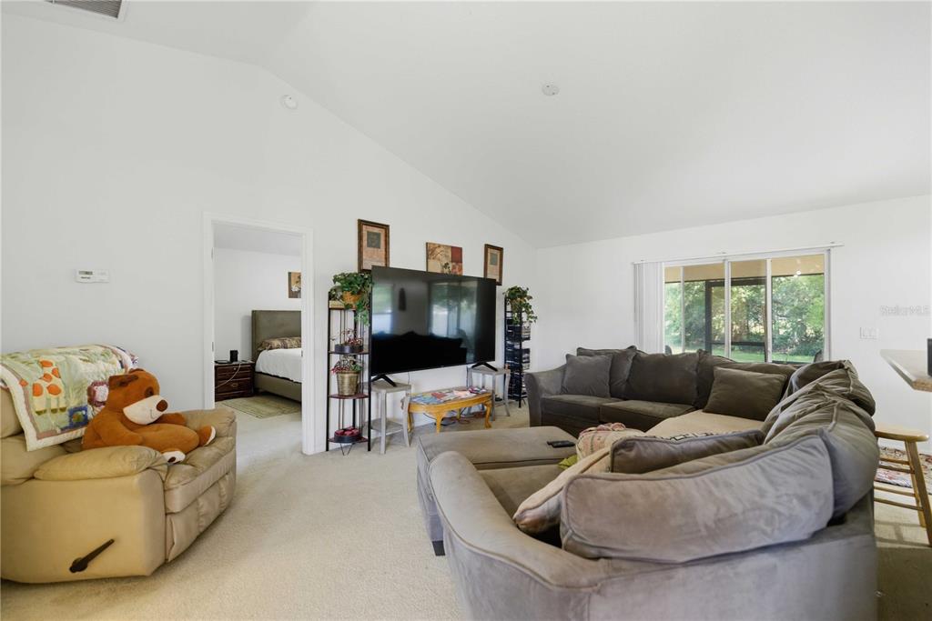 3959 Southwest 129th Street Ocala, FL 34473 - Photo 3 of 27 a living room with furniture and a flat screen tv