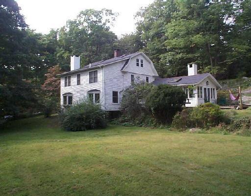 2 Indian Hill Road Wilton, CT 06897 - Photo 1 of 1 a front view of a house with a garden