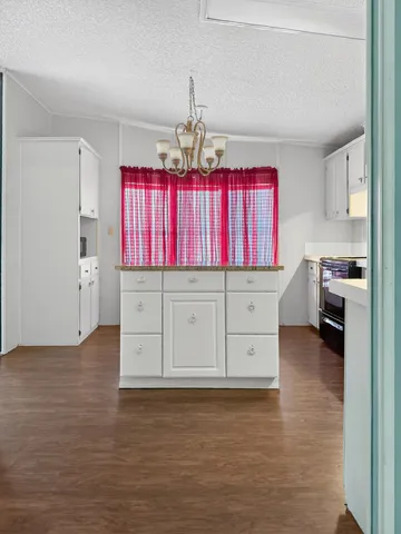 a kitchen with granite countertop a stove a sink and a granite counter tops