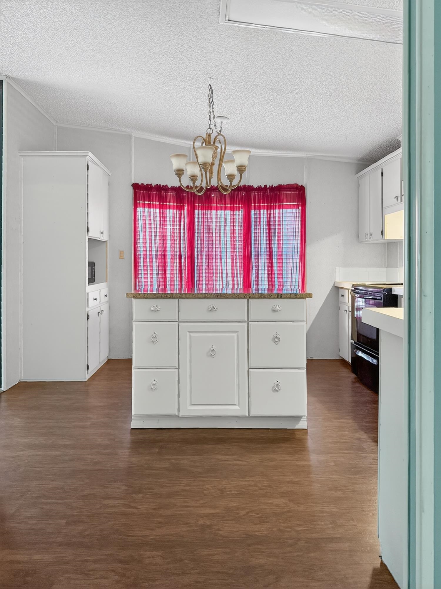 142 Garcia Street Interlachen, FL 32148 - Photo 23 of 28 a kitchen with stainless steel appliances kitchen island granite countertop a stove and a refrigerator
