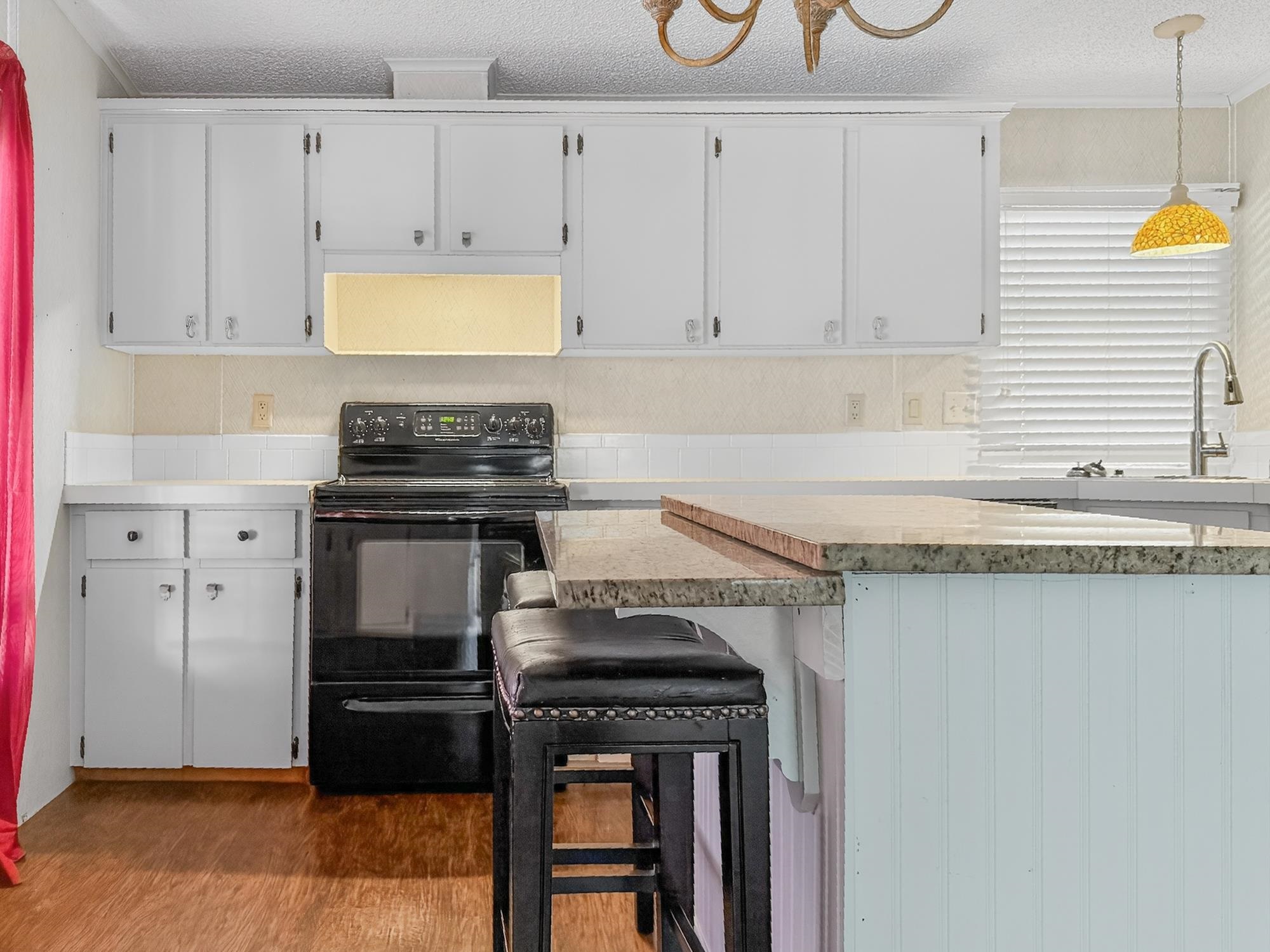 142 Garcia Street Interlachen, FL 32148 - Photo 24 of 28 a kitchen with granite countertop a stove a sink and a granite counter tops