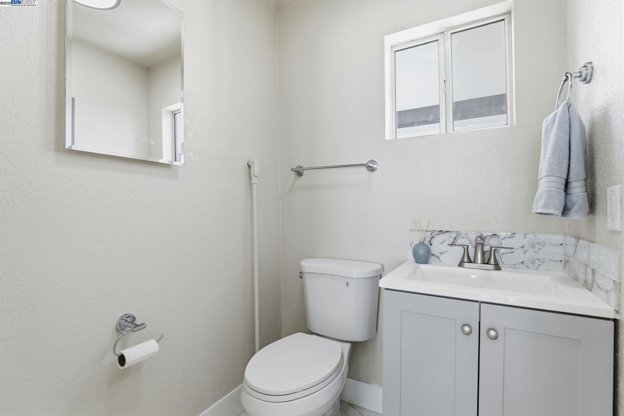 10745 Ridgeview Way San Jose, CA 95127 - Photo 16 of 54 a bathroom with a toilet sink vanity and mirror
