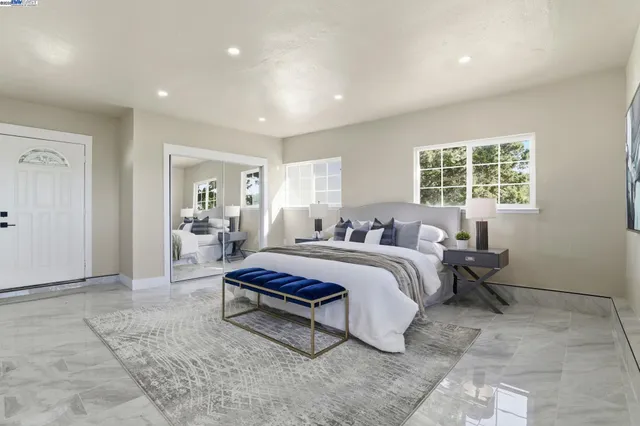 a spacious bedroom with a bed and a window