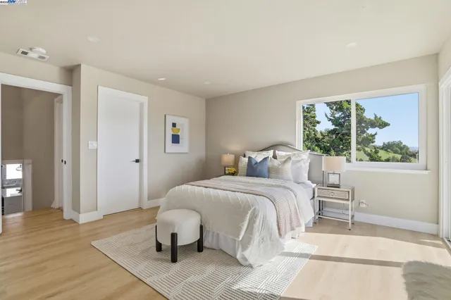 a bedroom with a bed and a large window