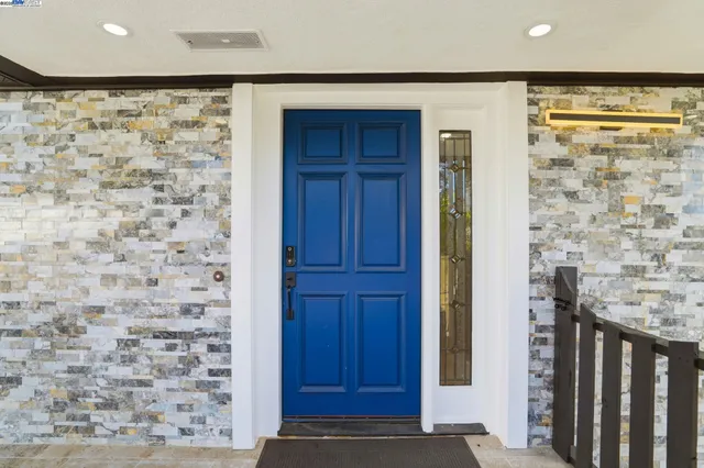 a view of a hallway with wooden door and wooden door