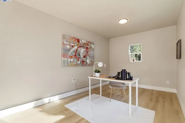 a room with furniture a window and wooden floor