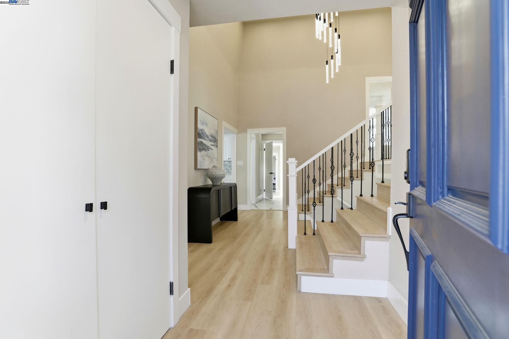 10745 Ridgeview Way San Jose, CA 95127 - Photo 4 of 54 a view of a hallway with wooden floor and staircase