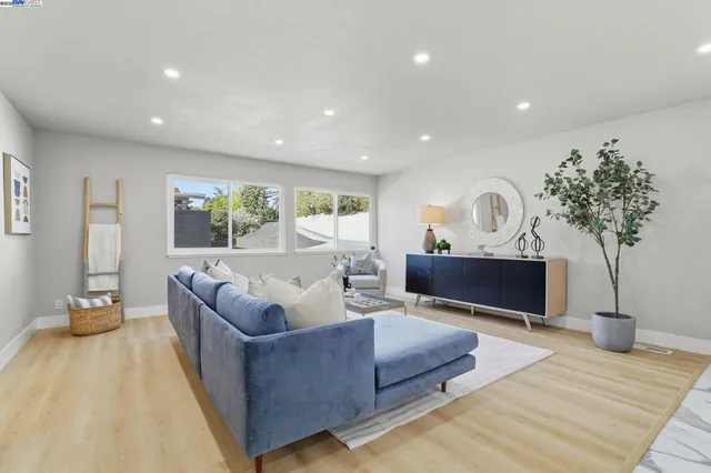 a living room with furniture and a potted plant