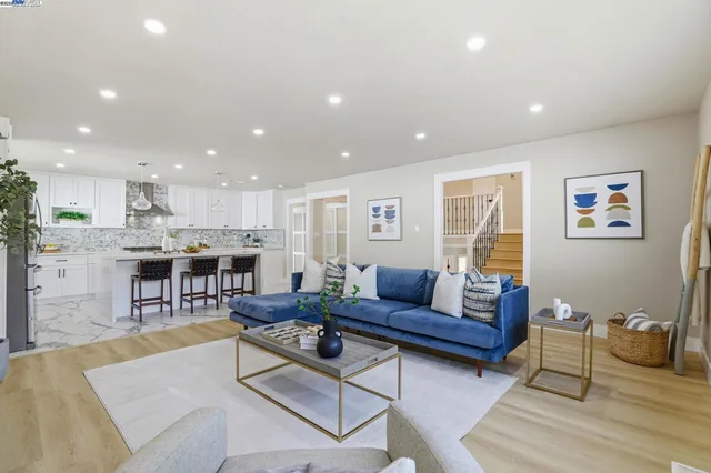 a living room with furniture and kitchen view