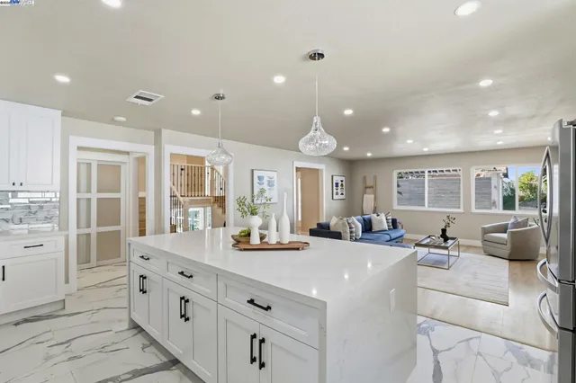 a kitchen with kitchen island cabinets and chairs