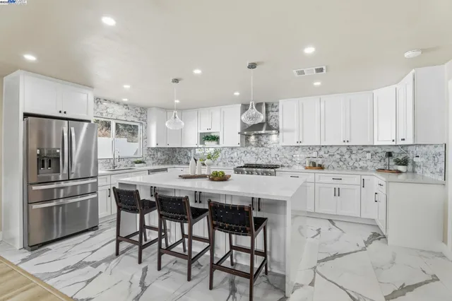 a kitchen with stainless steel appliances a sink and a refrigerator