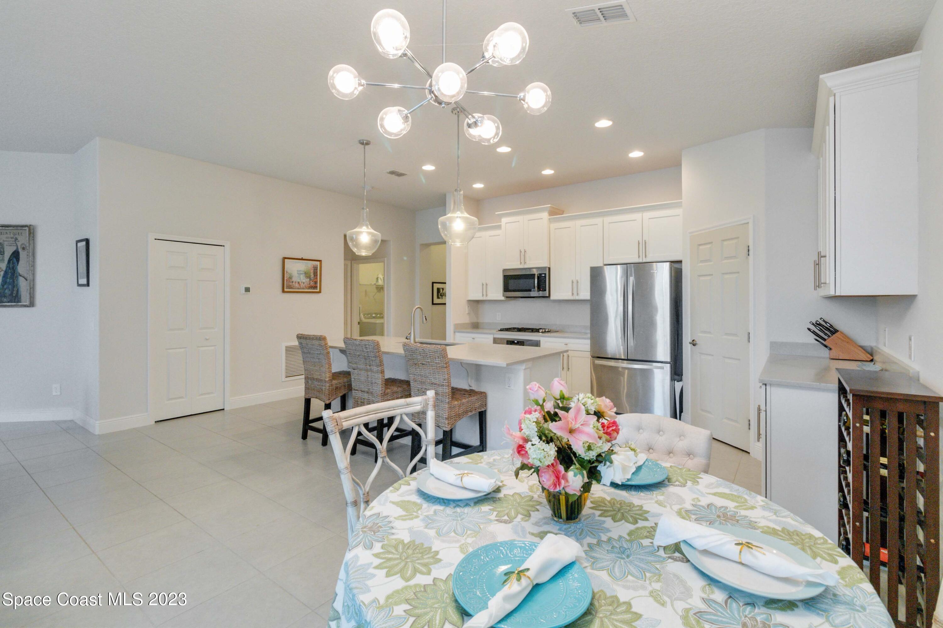 4215 Ruthann Circle Melbourne, FL 32934 - Photo 13 of 41 a kitchen with stainless steel appliances kitchen island granite countertop a refrigerator and a stove
