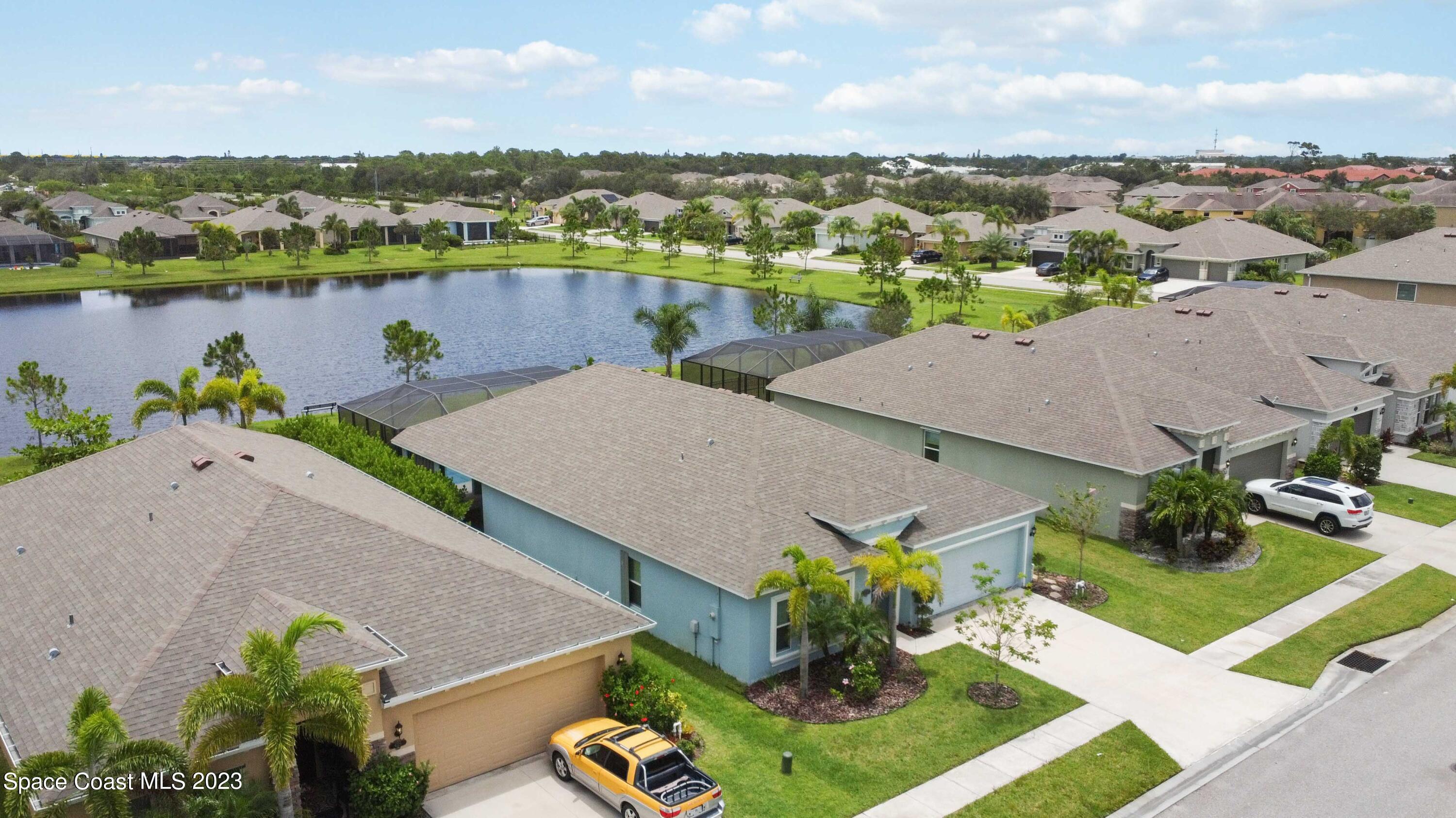 4215 Ruthann Circle Melbourne, FL 32934 - Photo 33 of 41 an aerial view of a house with garden space and lake view in back