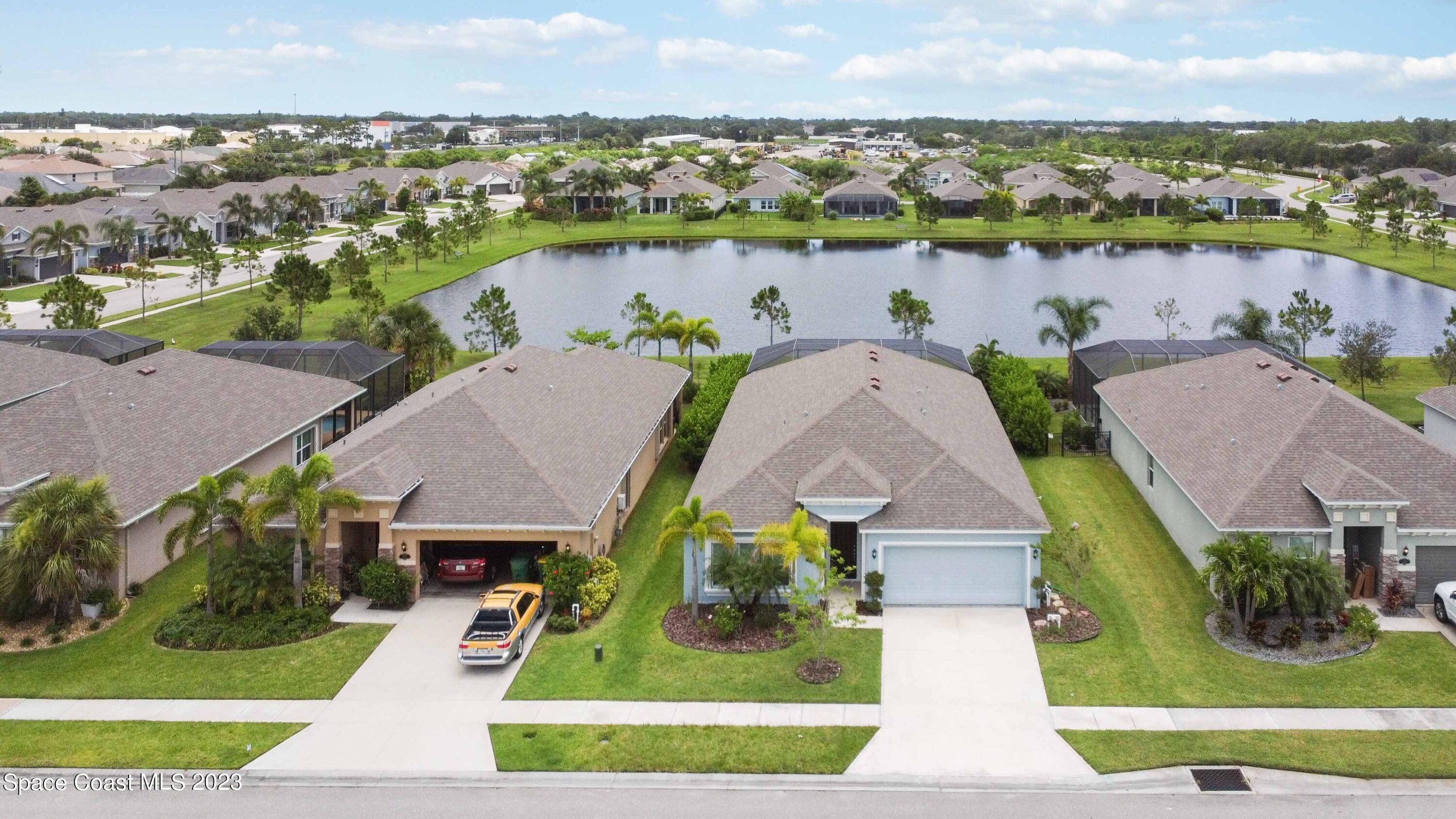 4215 Ruthann Circle Melbourne, FL 32934 - Photo 34 of 41 an aerial view of a house with a garden and lake view