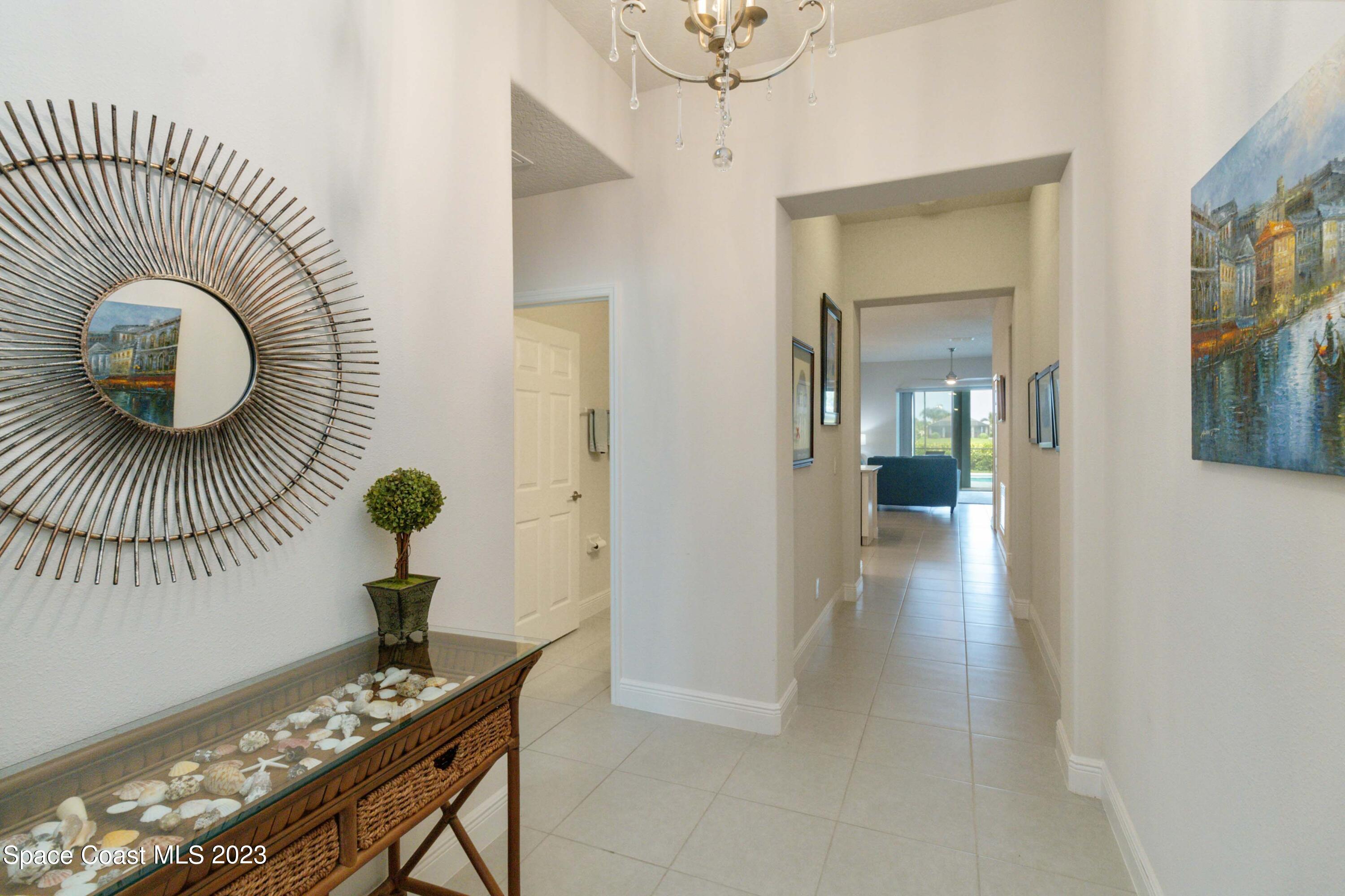 4215 Ruthann Circle Melbourne, FL 32934 - Photo 5 of 41 a view of hallway with furniture and wooden floor