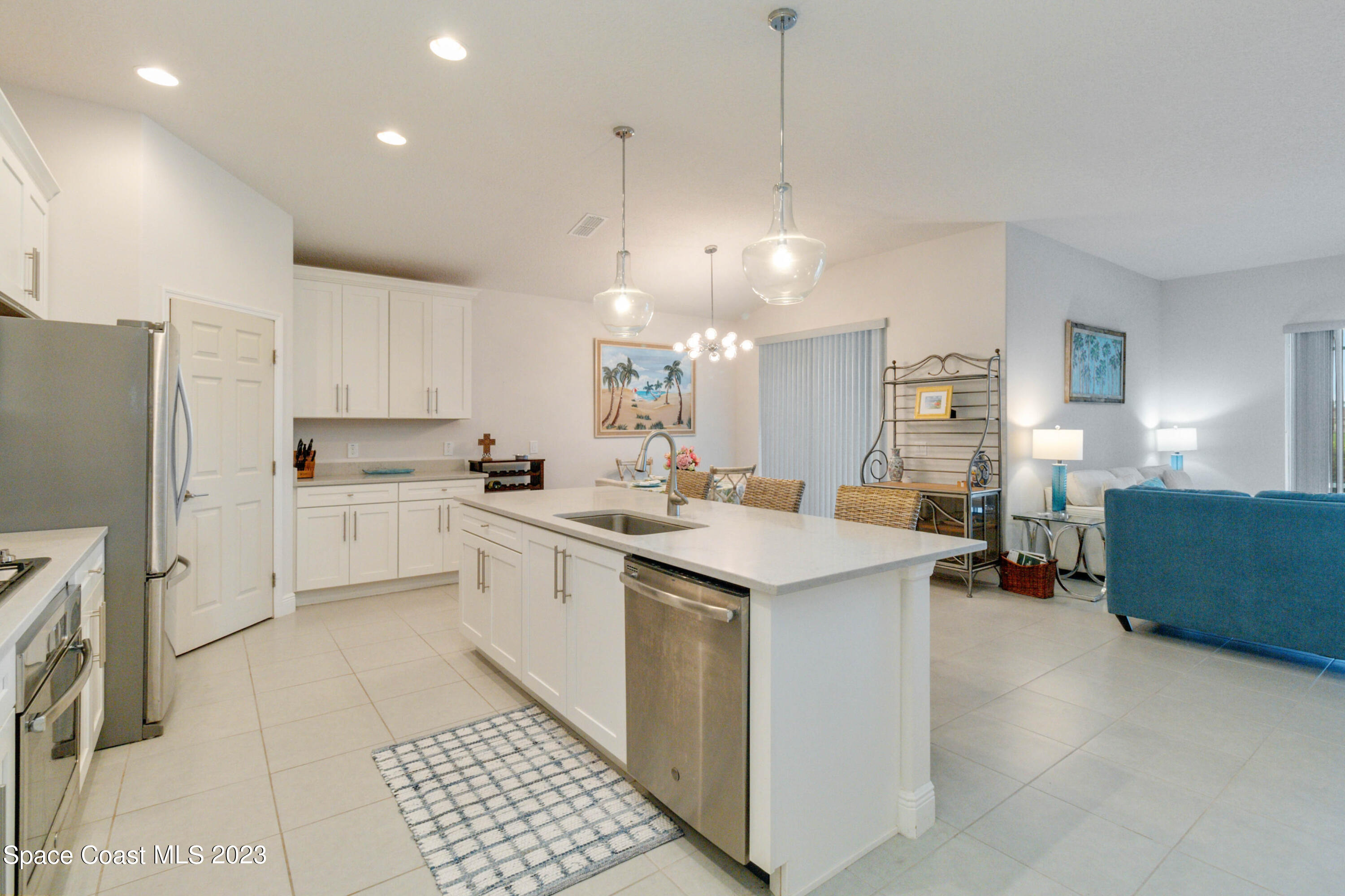 4215 Ruthann Circle Melbourne, FL 32934 - Photo 6 of 41 a kitchen with a sink a counter top space stainless steel appliances and cabinets