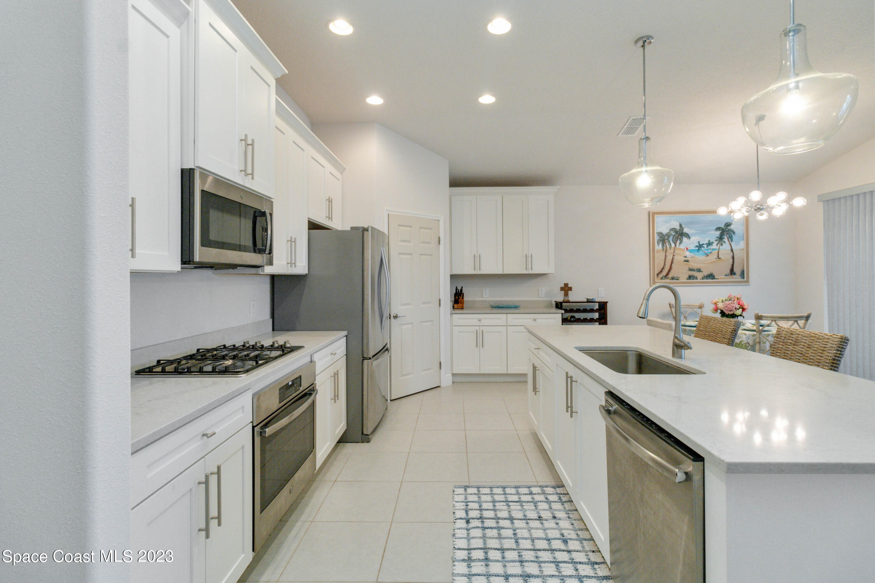 4215 Ruthann Circle Melbourne, FL 32934 - Photo 7 of 41 a kitchen with stainless steel appliances granite countertop a sink stove and refrigerator