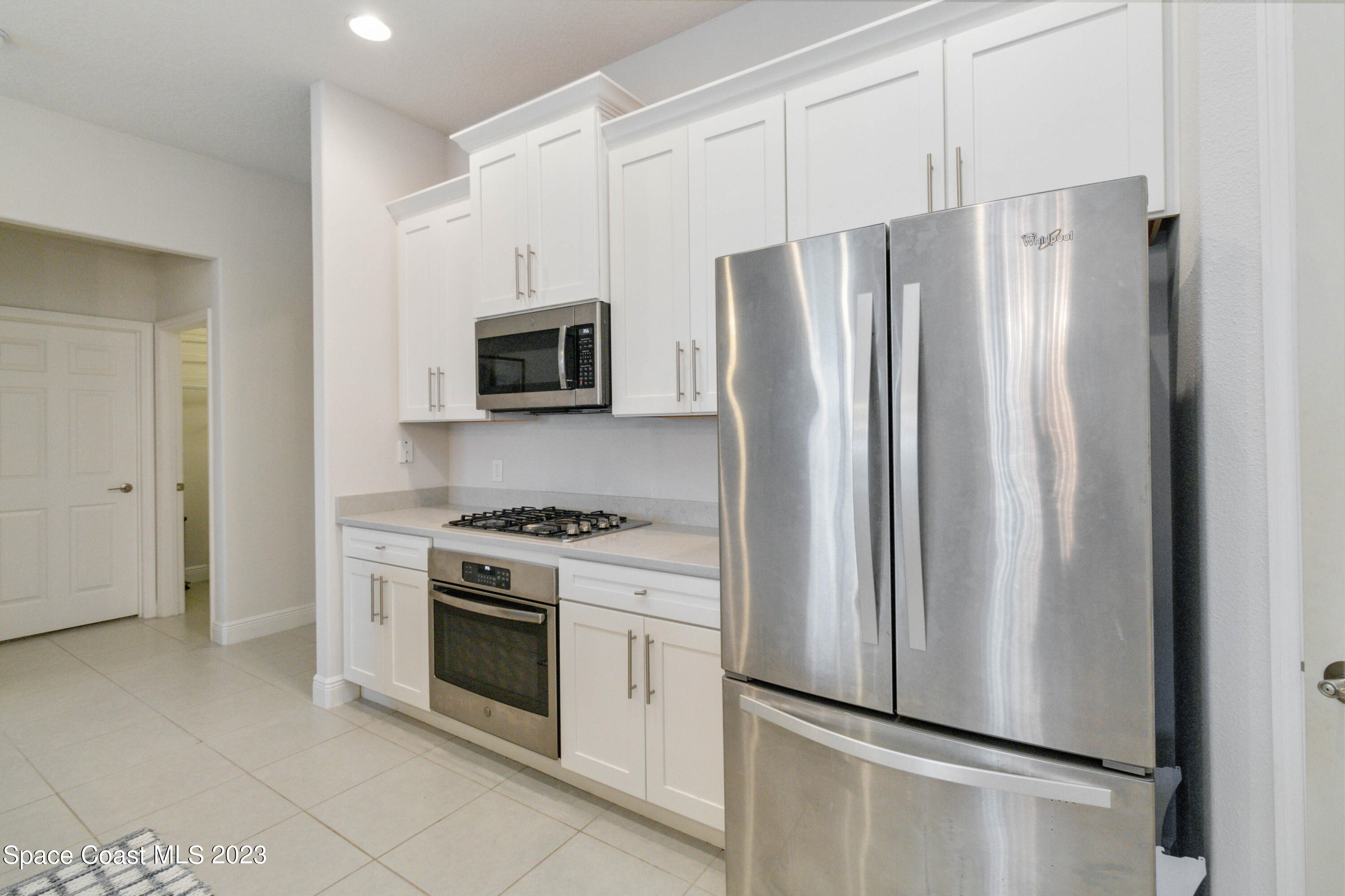 4215 Ruthann Circle Melbourne, FL 32934 - Photo 10 of 41 a kitchen with stainless steel appliances a refrigerator stove and microwave