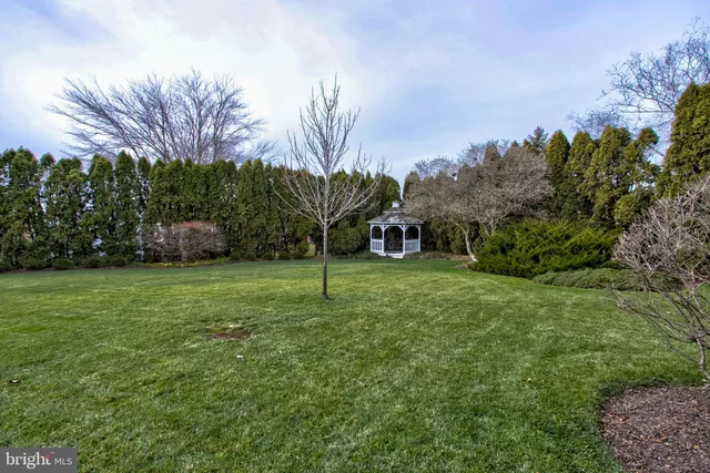 a view of a house with swimming pool and a yard