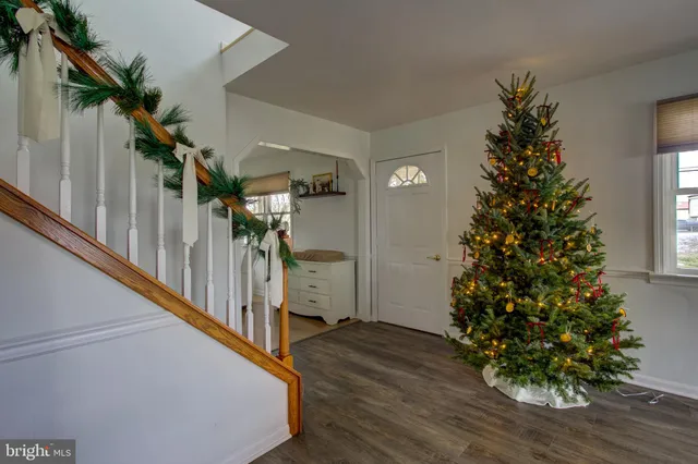 a kitchen with a refrigerator a sink dishwasher with a dining table and chairs