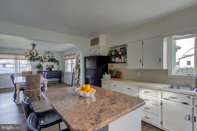 a vase of flowers sitting on a floor