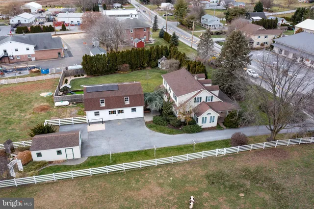 an aerial view of a house with a garden and lake view