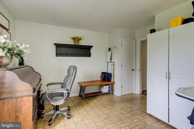 a bathroom with granite countertop a sink a toilet and a mirror