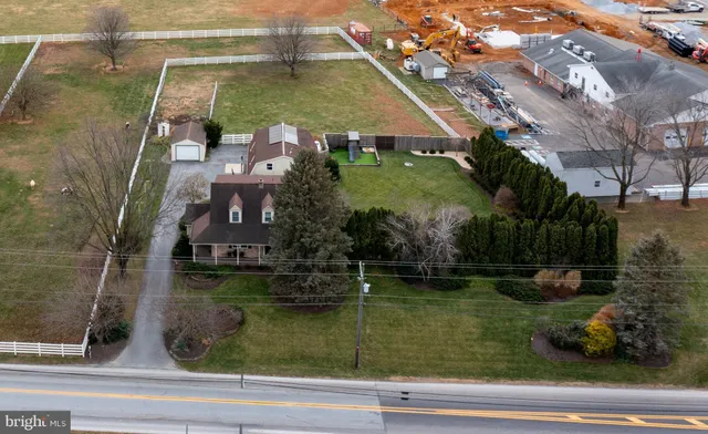an aerial view of a house with garden space and street view