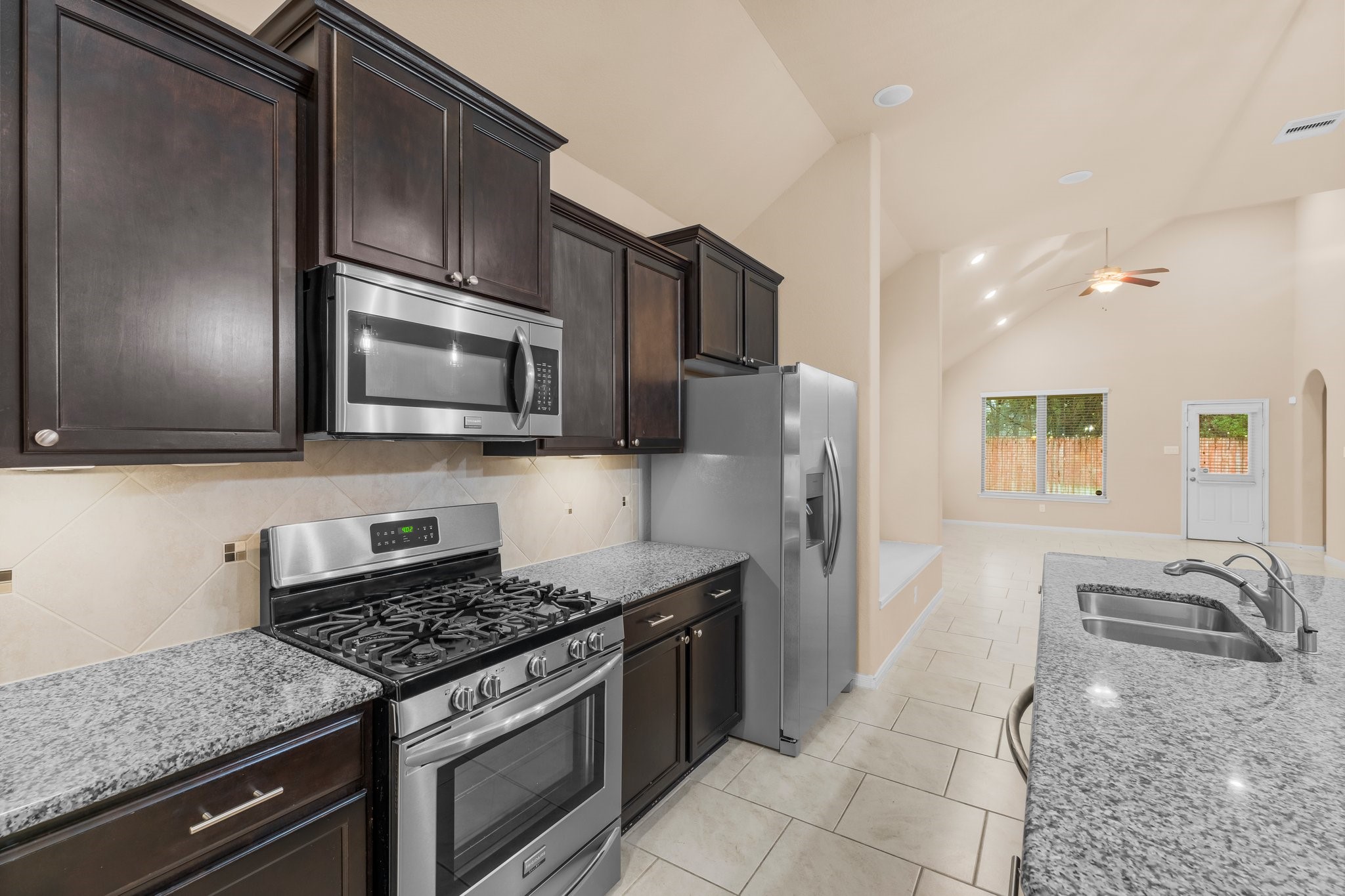 22314 Forbes Field Trail Spring, TX 77389 - Photo 13 of 46 Kitchen features 5 burner gas range/oven, microwave, dishwasher, and refrigerator. it is open to the large breakfast area.