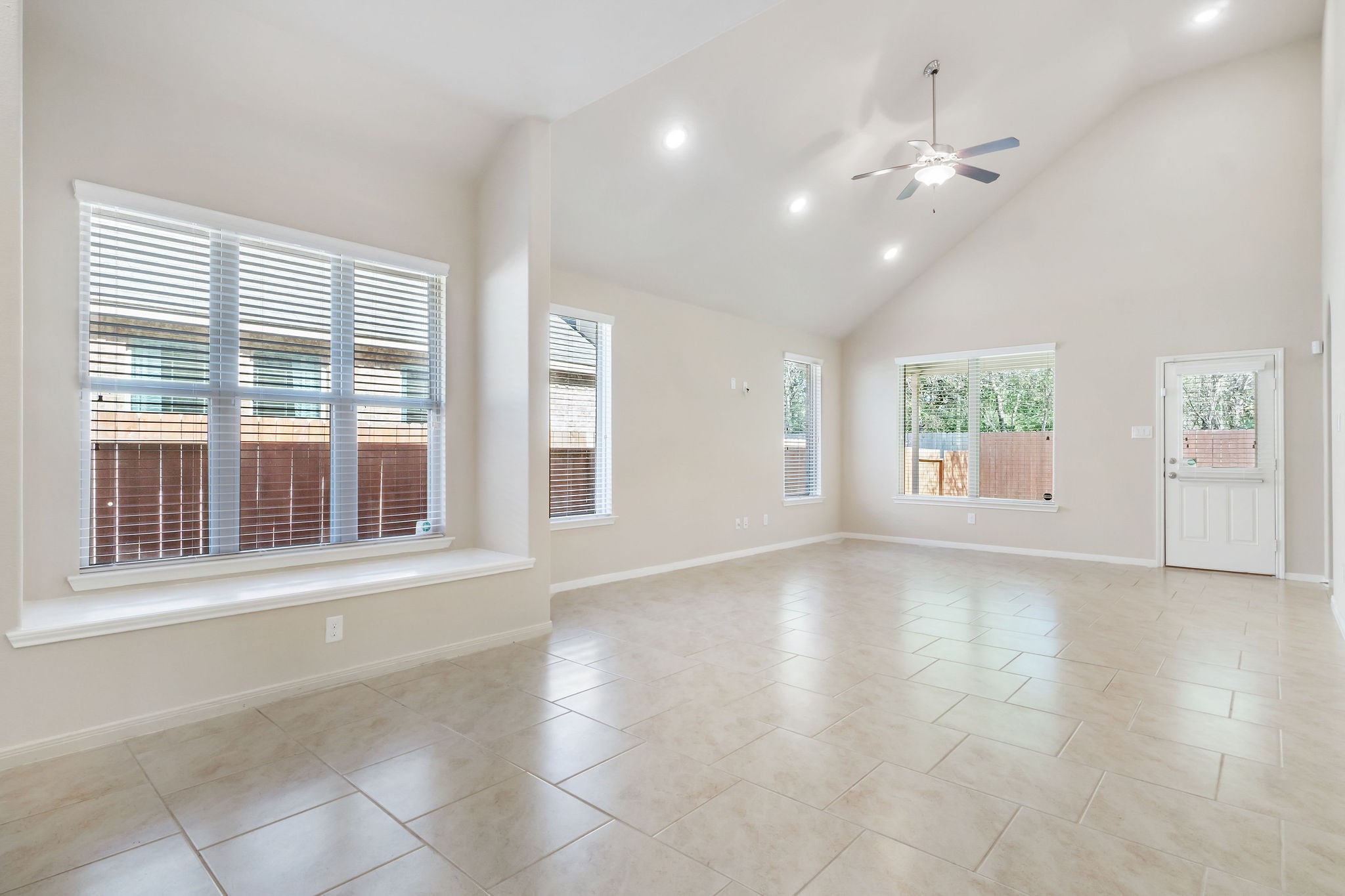 22314 Forbes Field Trail Spring, TX 77389 - Photo 14 of 46 Spacious, well-lit room with a huge triple window and window seat adjacent to the Den, offering ample natural light and a cozy seating area.