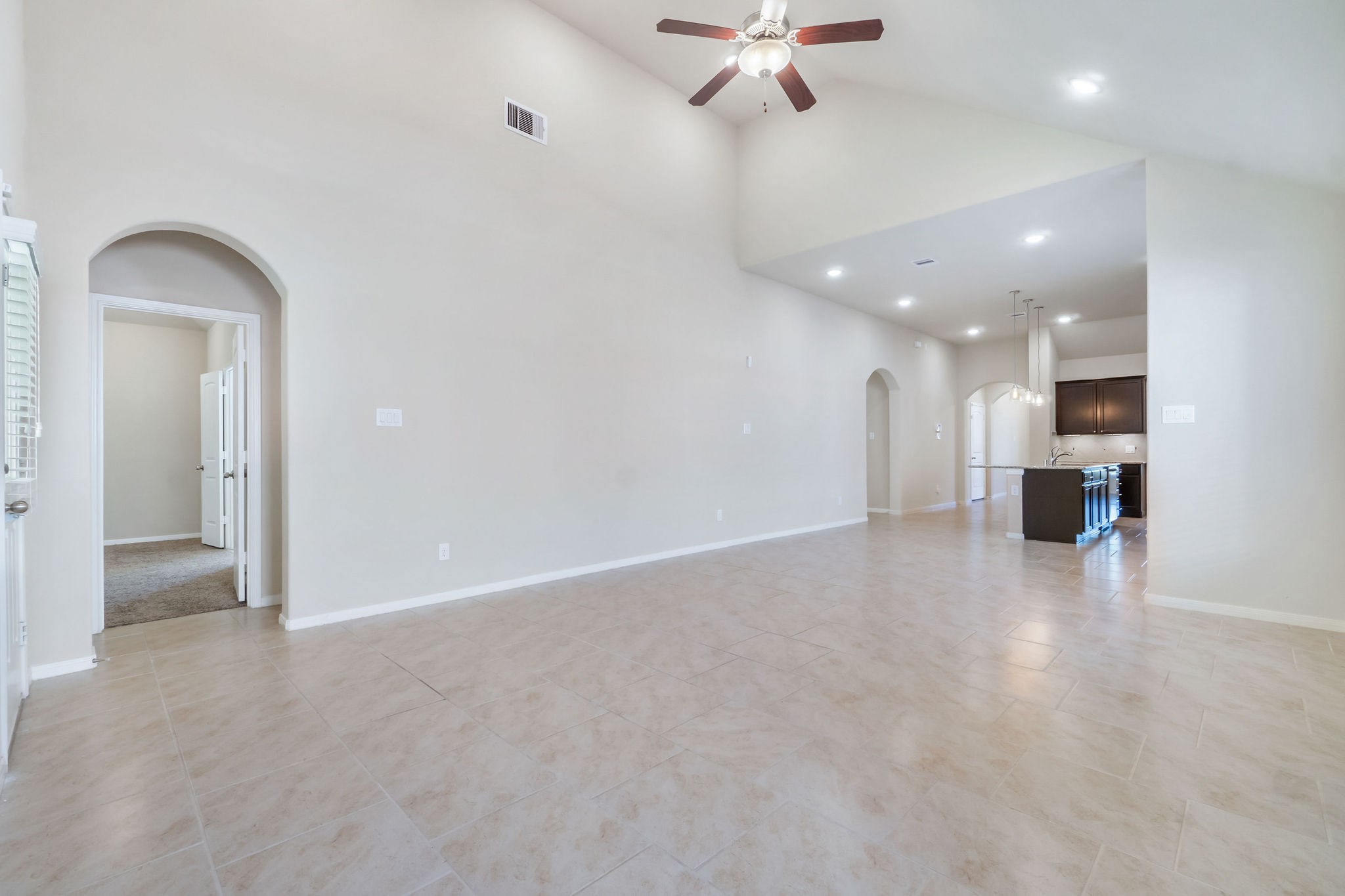 22314 Forbes Field Trail Spring, TX 77389 - Photo 17 of 46 Features of the Den include tile flooring, vaulted ceiling, large windows, recessed lighting, and ceiling fan with light.