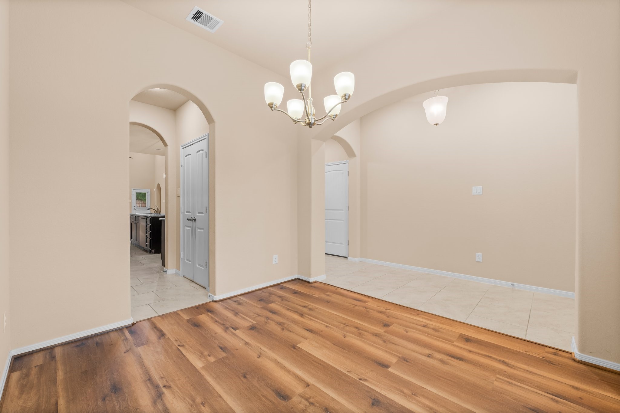 22314 Forbes Field Trail Spring, TX 77389 - Photo 5 of 46 Formal Dining room is great for entertaining. Note the arched entry ways. Newer wood flooring 2025. There is also a butler's pantry between the Dining Room and Kitchen for ease in entertaining!