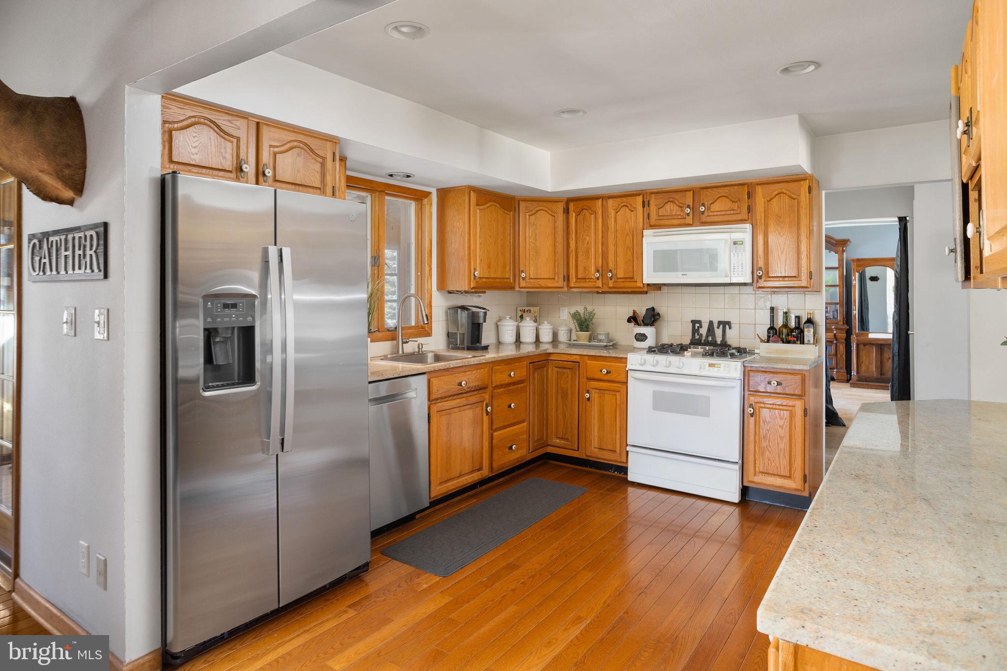 9 Sabrina Drive Ewing, NJ 08618 - Photo 14 of 49 a kitchen with a refrigerator a sink a stove top oven and kitchen island