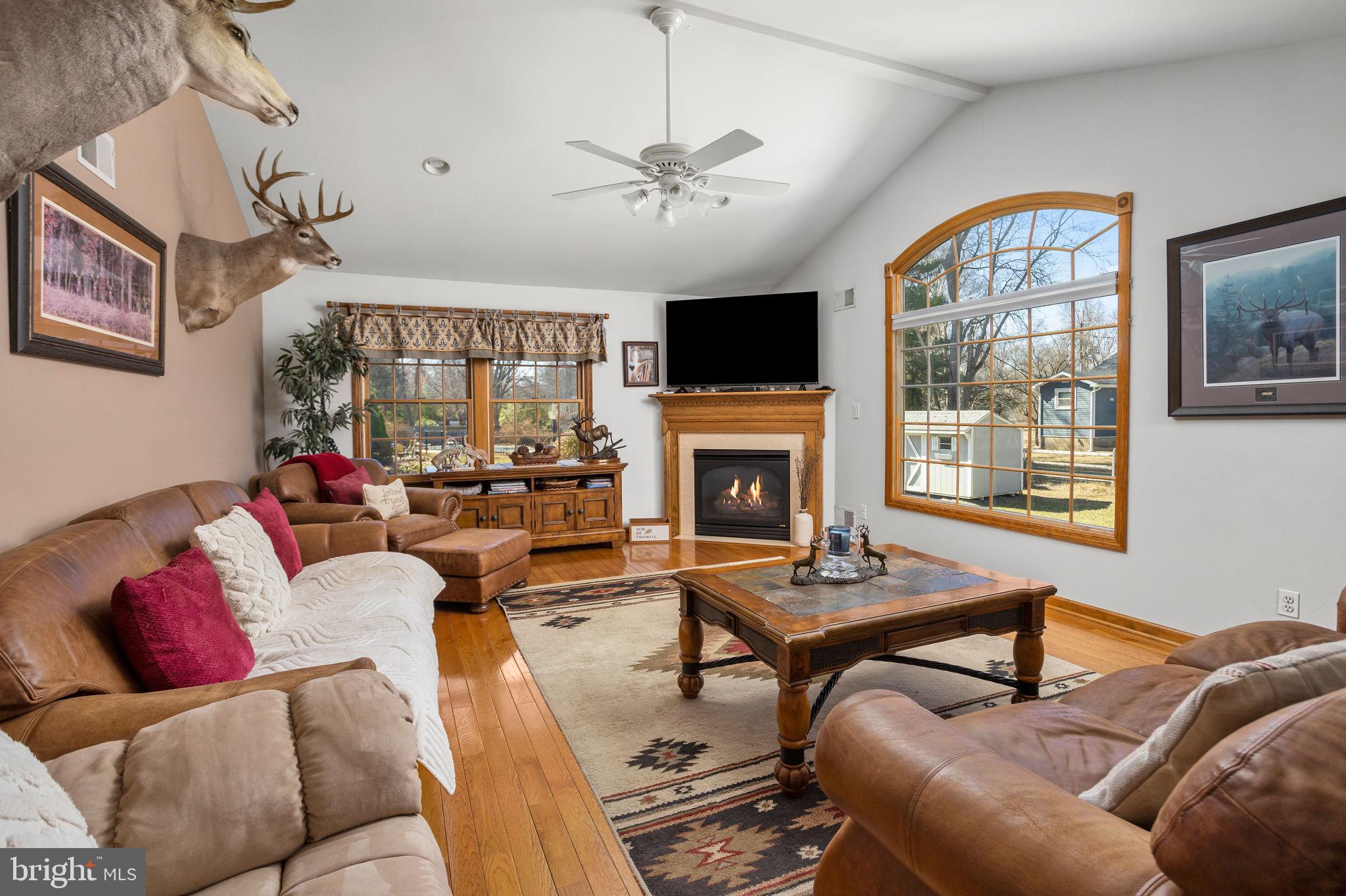 9 Sabrina Drive Ewing, NJ 08618 - Photo 22 of 49 a living room with furniture a fireplace and a flat screen tv