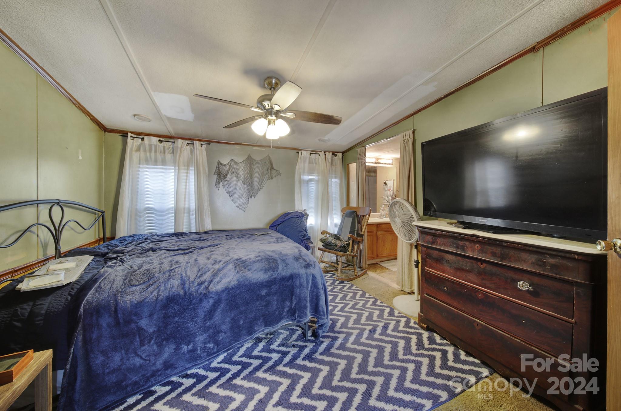 1950 Knight Road Lancaster, SC 29720 - Photo 13 of 24 a bedroom with a bed and a flat screen tv