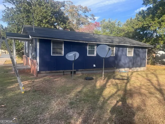 a backyard of a house with table and chairs
