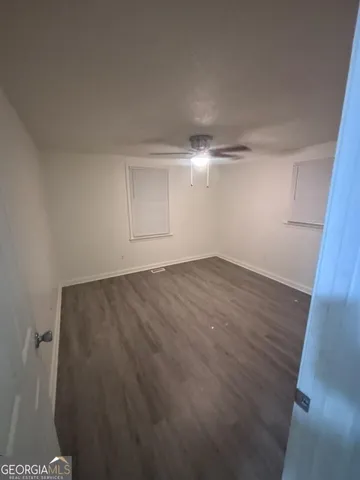 a view of a room with wooden floor