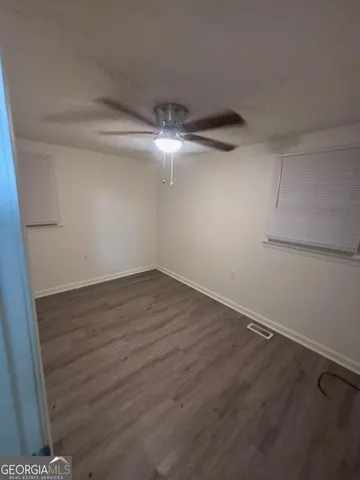 a view of a room with wooden floor