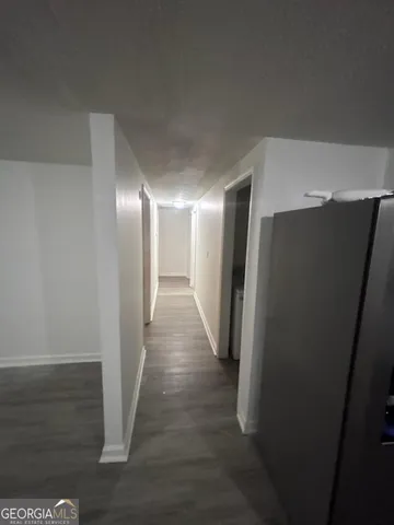 a view of hallway with wooden floor